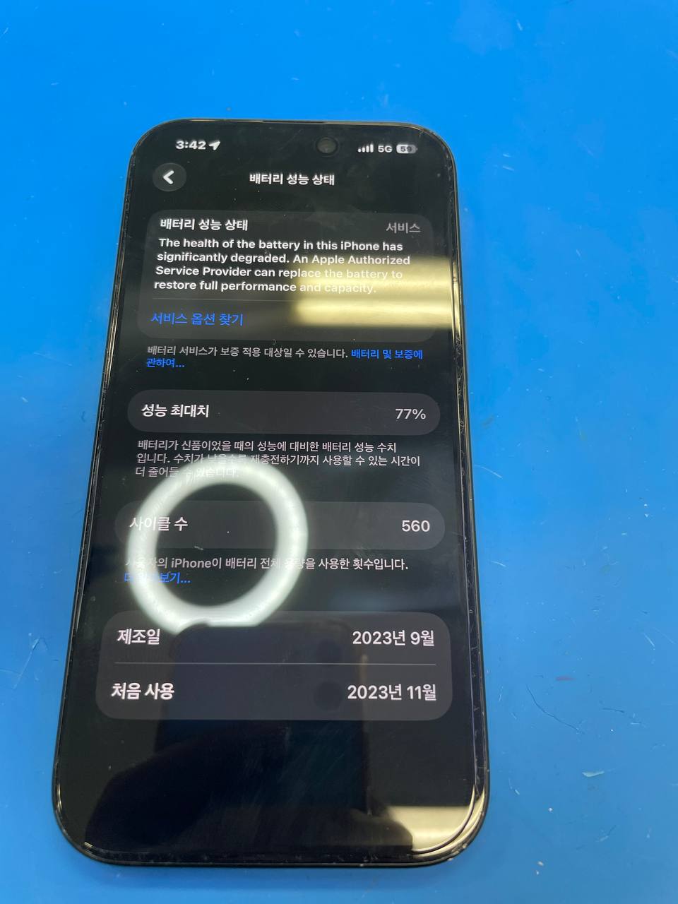 강변점 아이폰 15 배터리교체 ( 성능 77% ) 수리사례 상세사진 1번 이미지입니다. [광진구 아이폰수리] 전면 유리 미세파손으로 공식 수리가 어려웠던 아이폰15 배터리교체｜성능 77% 관련 1번째 수리 단계로, 입고된 기기의 외관 상태와 파손 부위를 확인하는 초기 점검 장면입니다.